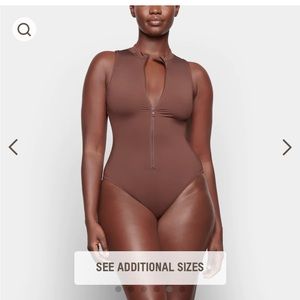 Skims zip front sleeveless swim suit